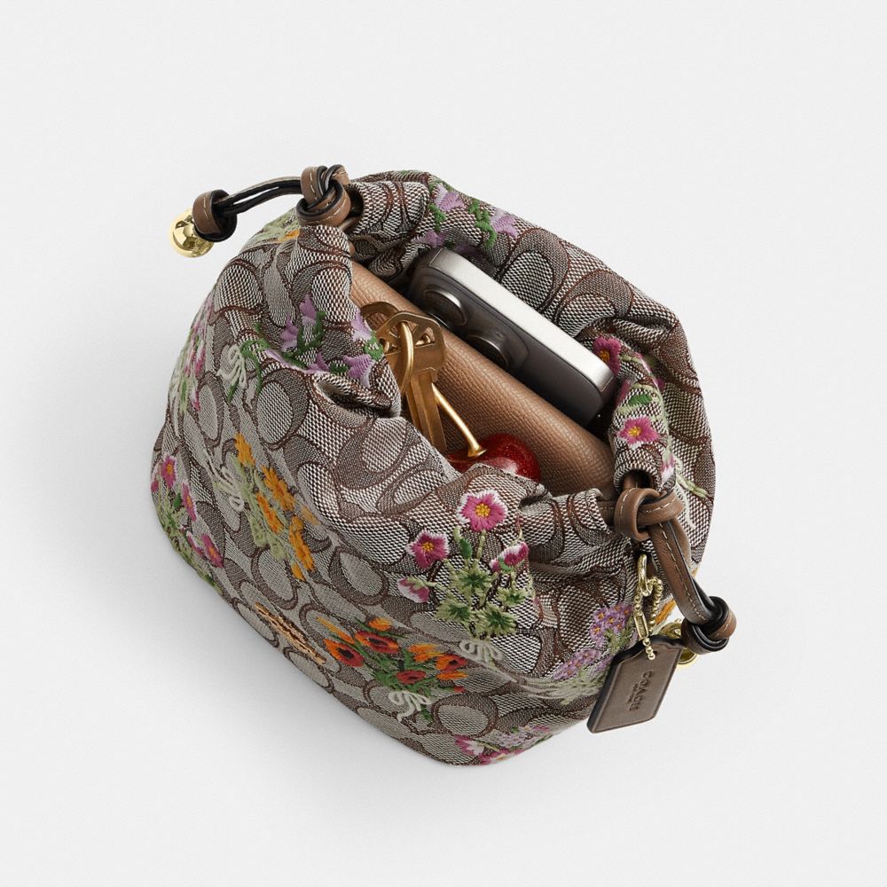 Coach Faye Mini Drawstring Bag In Signature Jacquard With Floral Embroidery Gold Oak Multi