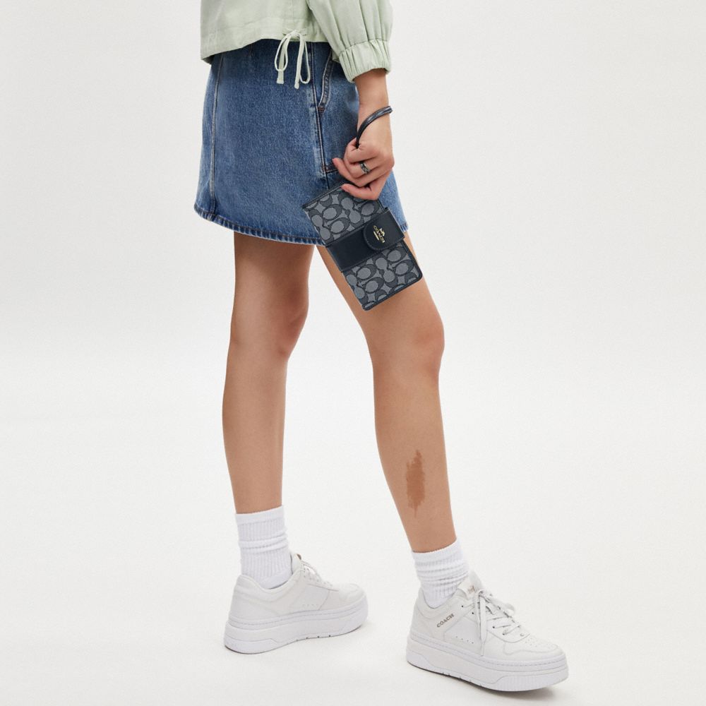 Coach Phone Wallet In Signature Jacquard Gold Navy Midnight Navy
